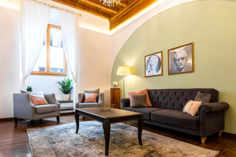 Living room with arch and sofas, Florence Palace apartment in Santa Croce