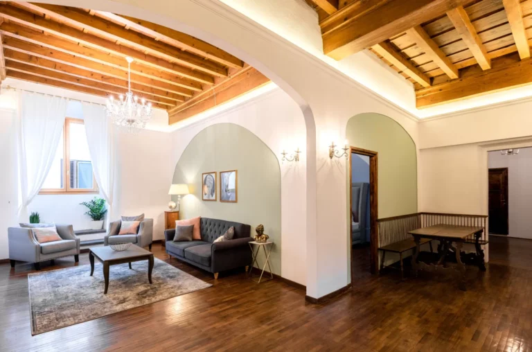 Living room with wooden beamed ceiling, Florence Palace apartment in Santa Croce